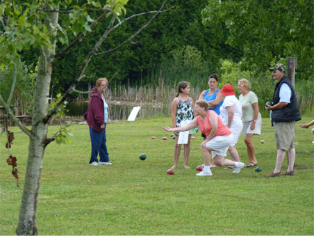 Playing bocce ball by the pond